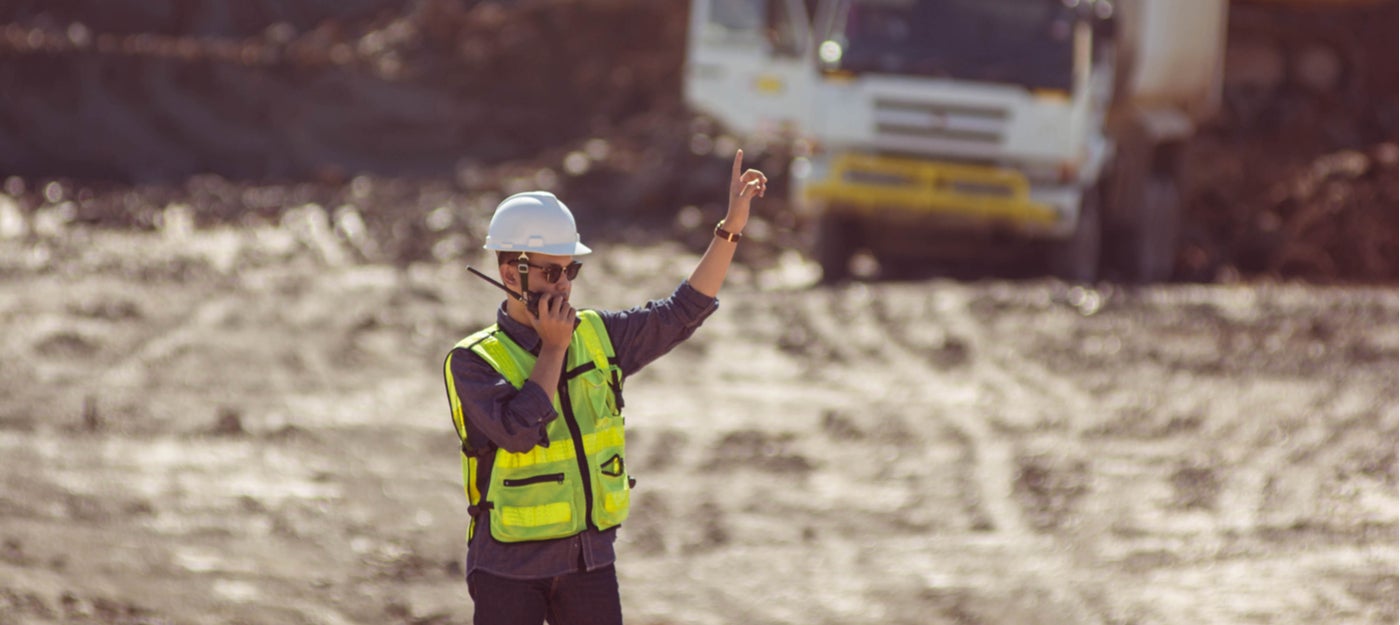 Mine worker using PBE Axell leaky feeder communication system