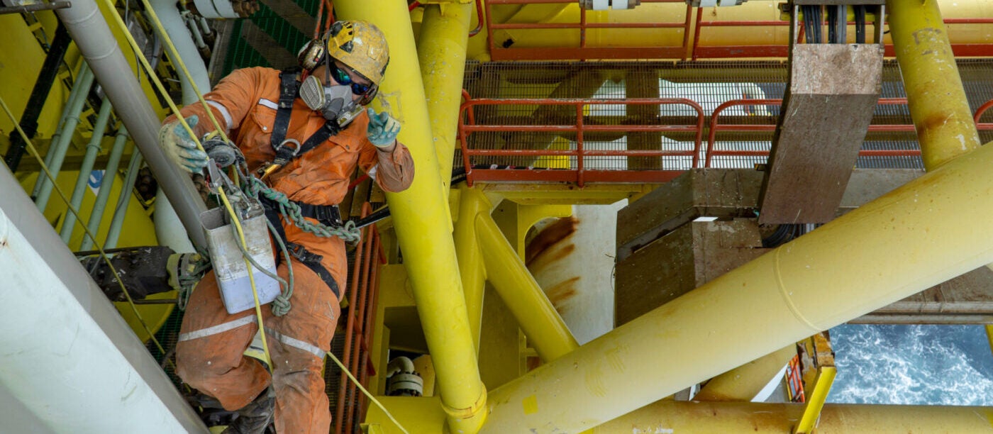 Worker wearing SCBR respirator working offshore