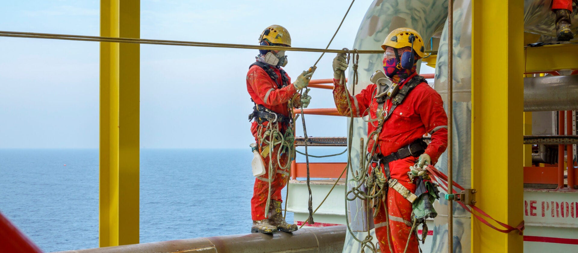Workers wearing PPE equipment offshore in oil and gas industry