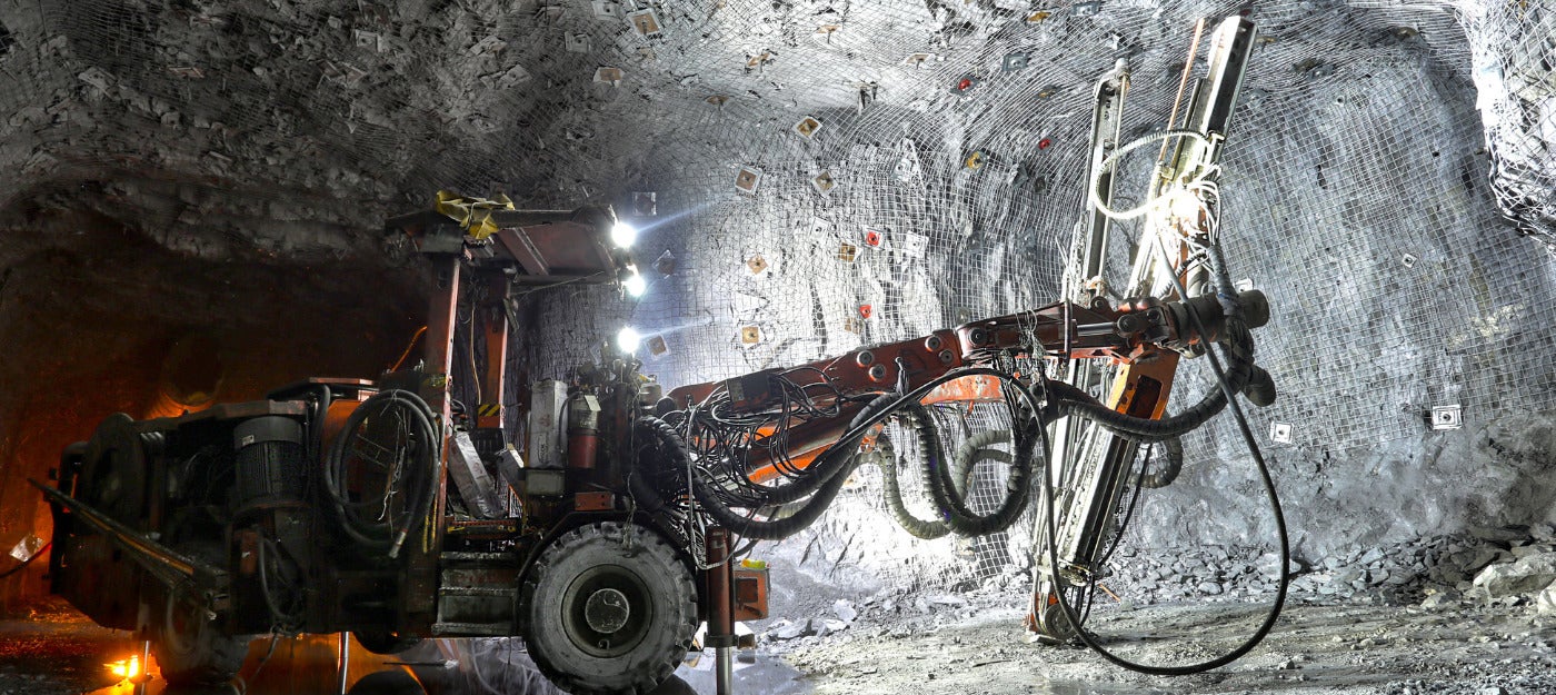 Mining vehicle creating dust in an underground mine