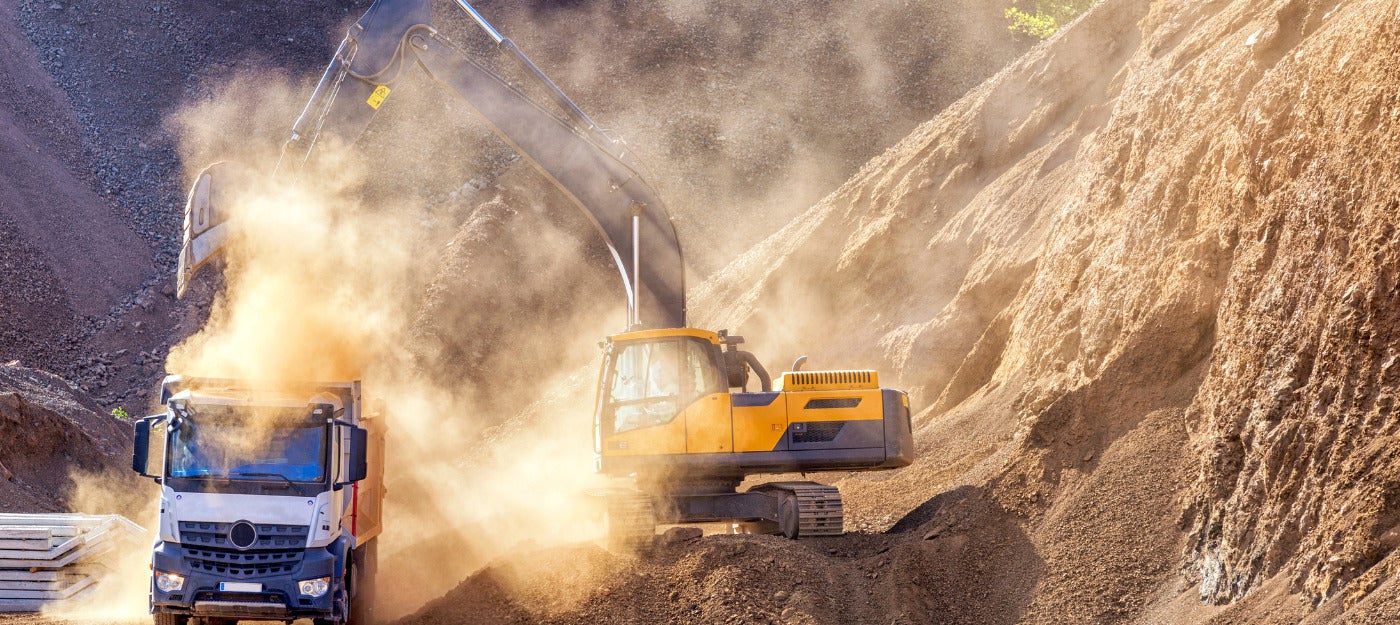 Mining excavator kicking up a lot of dust