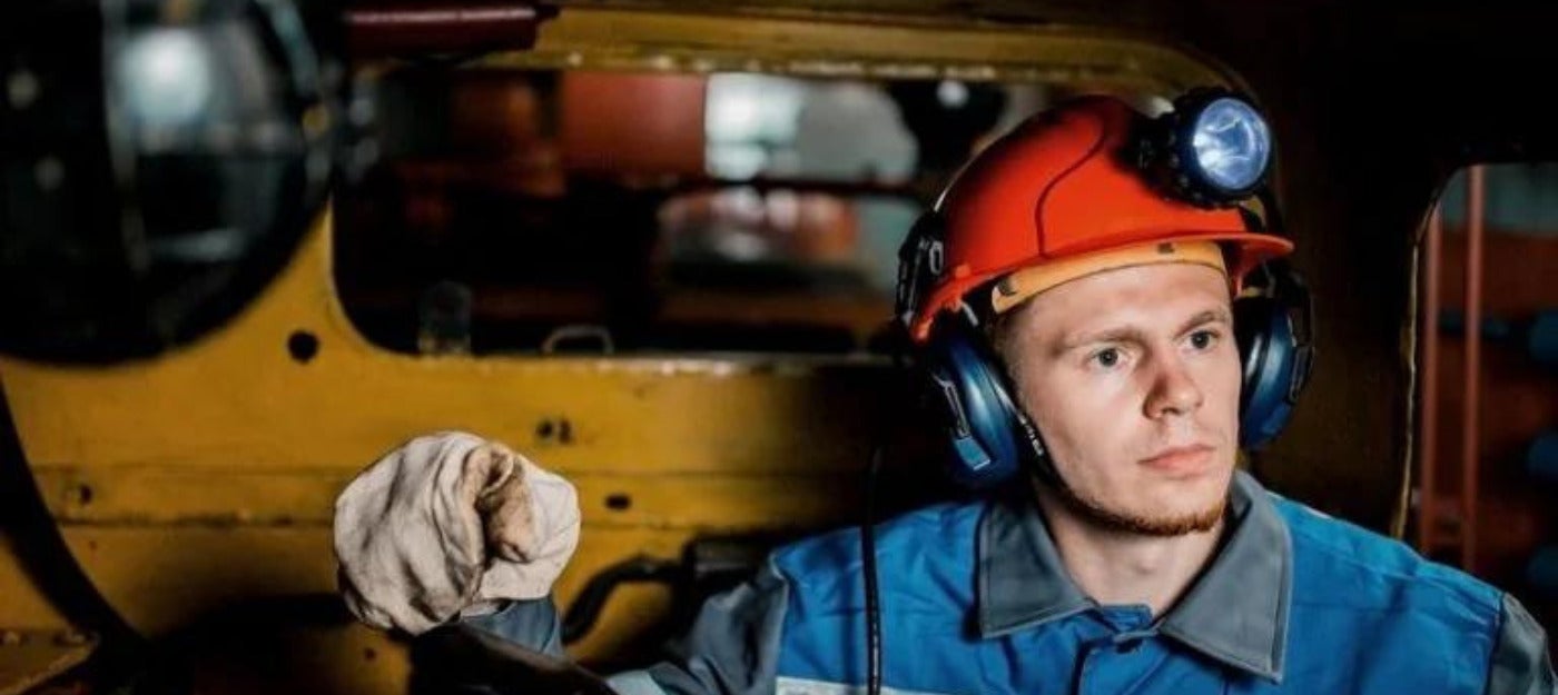 Miner wearing hard hat fitted with cap light